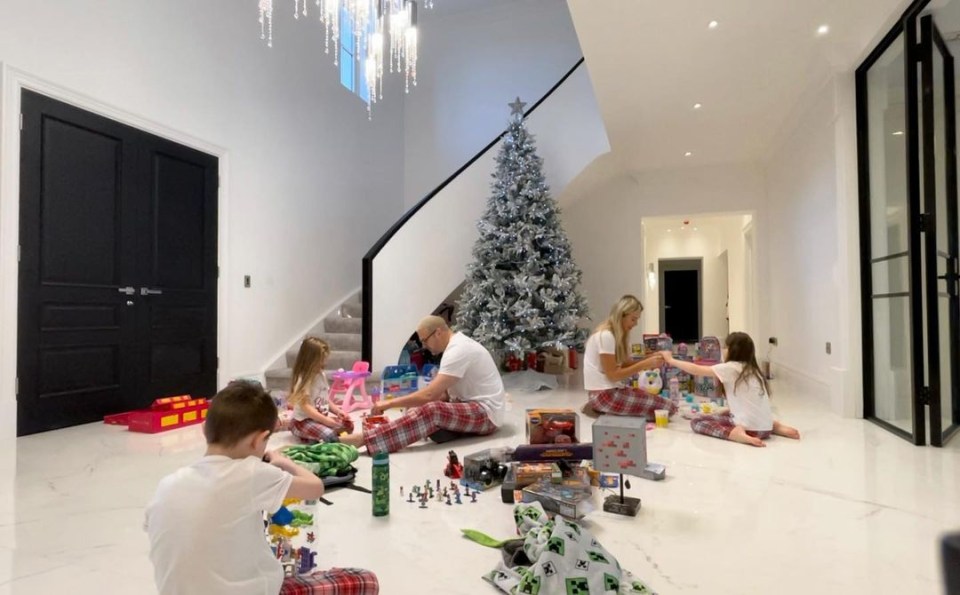 The couple and their children celebrating Christmas in the house