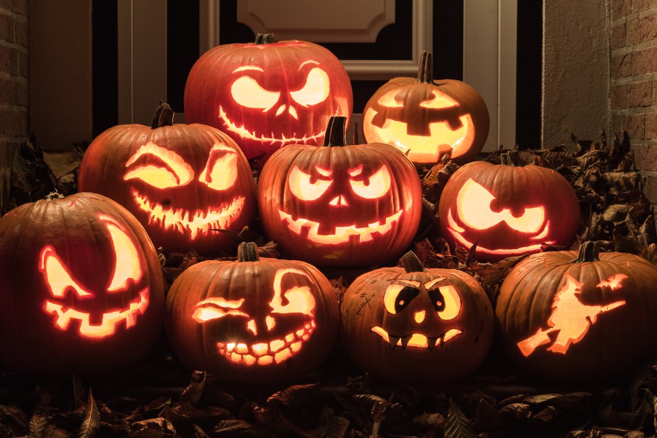 a bunch of pumpkins with faces carved into them