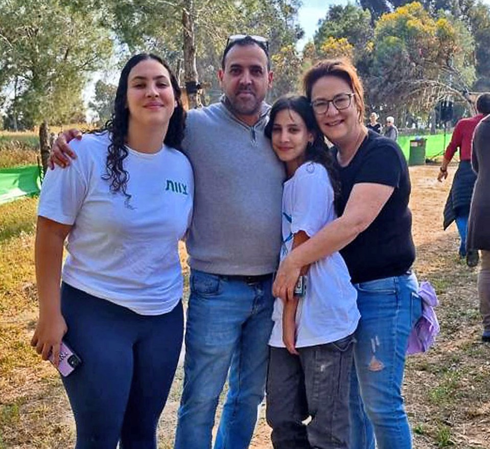 a group of people are posing for a picture in a park .