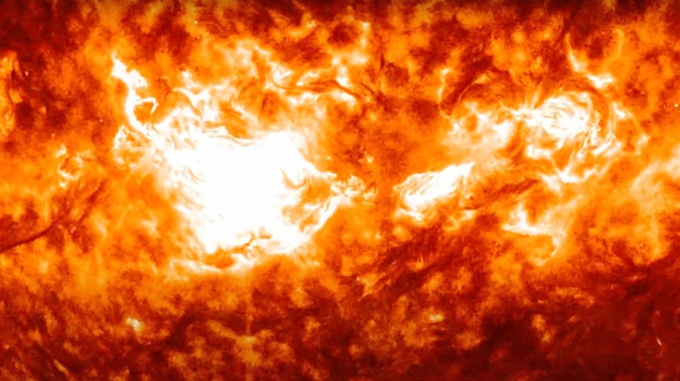 a close up of the sun with a white spot in the middle