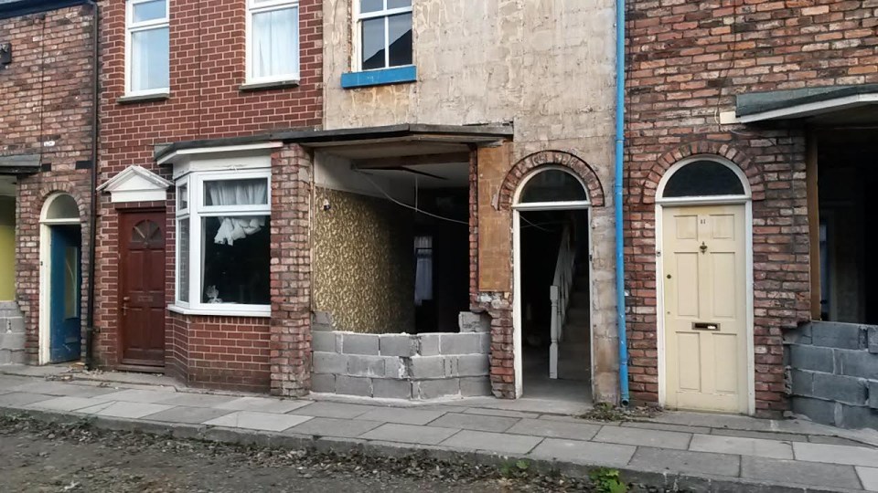 a brick building with a yellow door and a red door