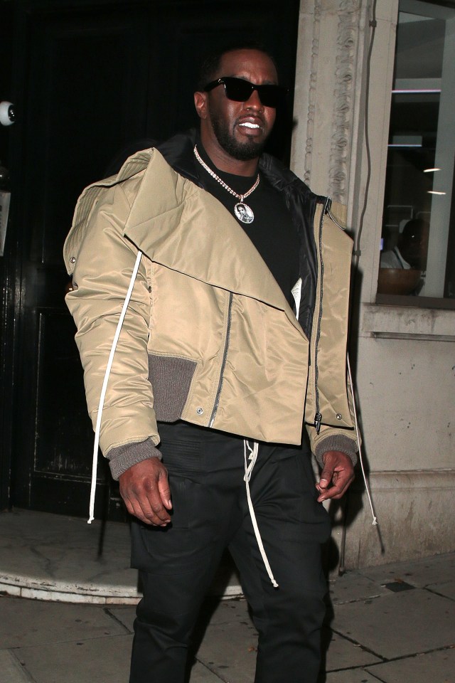 a man wearing sunglasses and a jacket with a pendant that says ' jesus ' on it