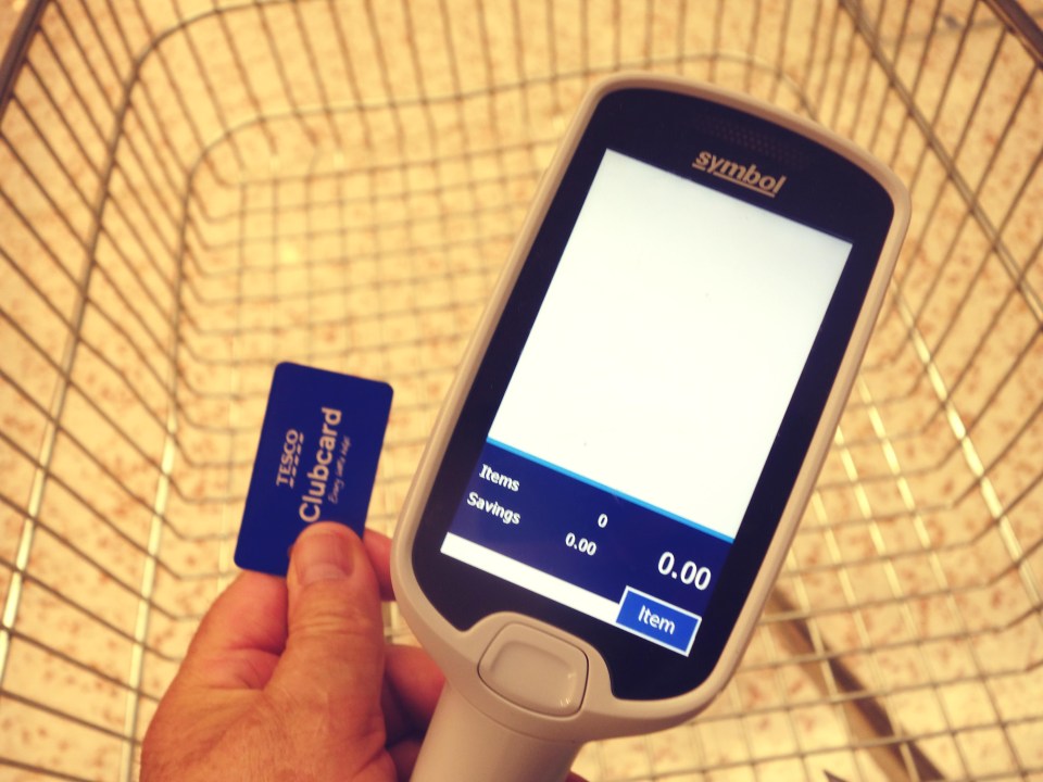 a person holding a clubcard next to a symbol device