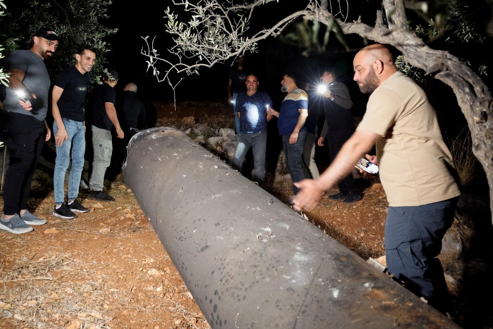 Palestinians investigate a projectile in Tubas