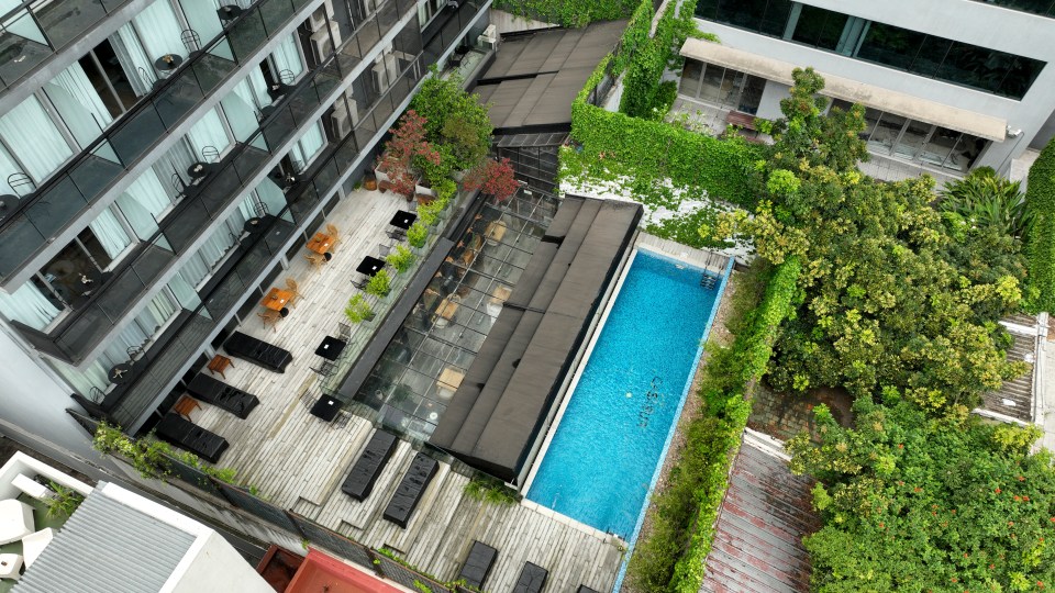 an aerial view of a hotel with a large swimming pool