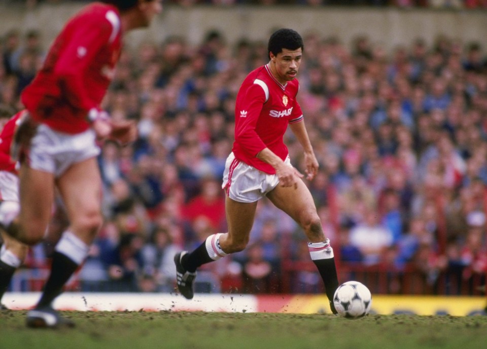 a man in a red shirt with the word shaw on it