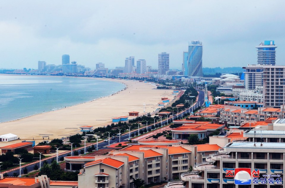 an aerial view of a city with buildings and a beach