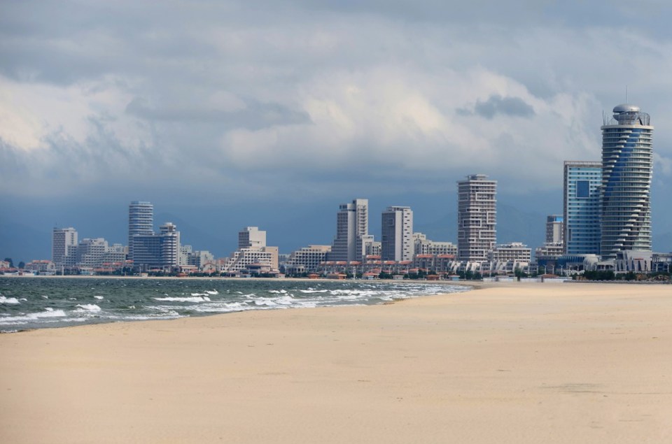 a beach with a city skyline in the background