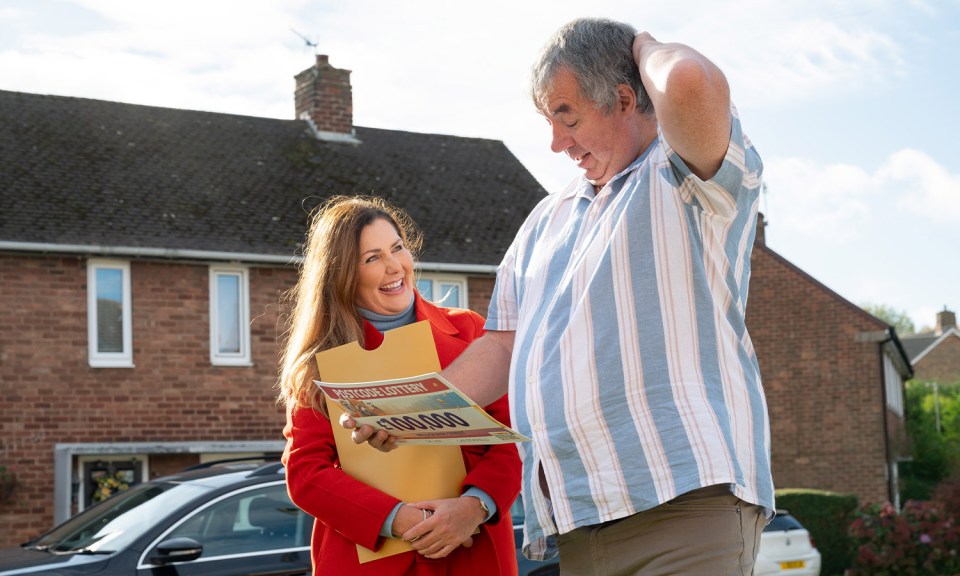 a man and a woman are looking at a lottery ticket