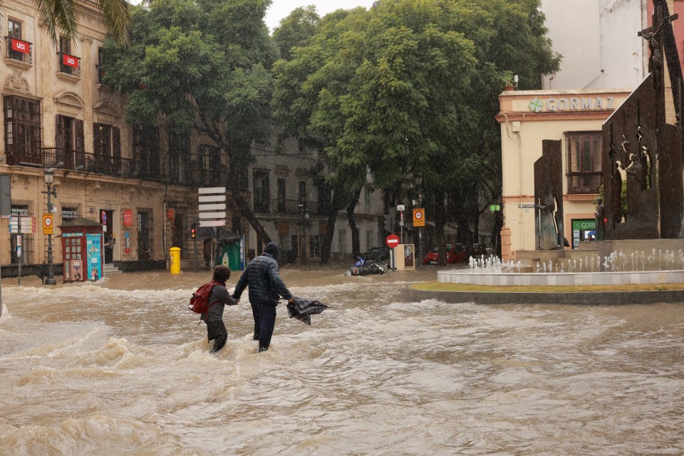 a flooded street with a sign that says ' farmacia ' on it