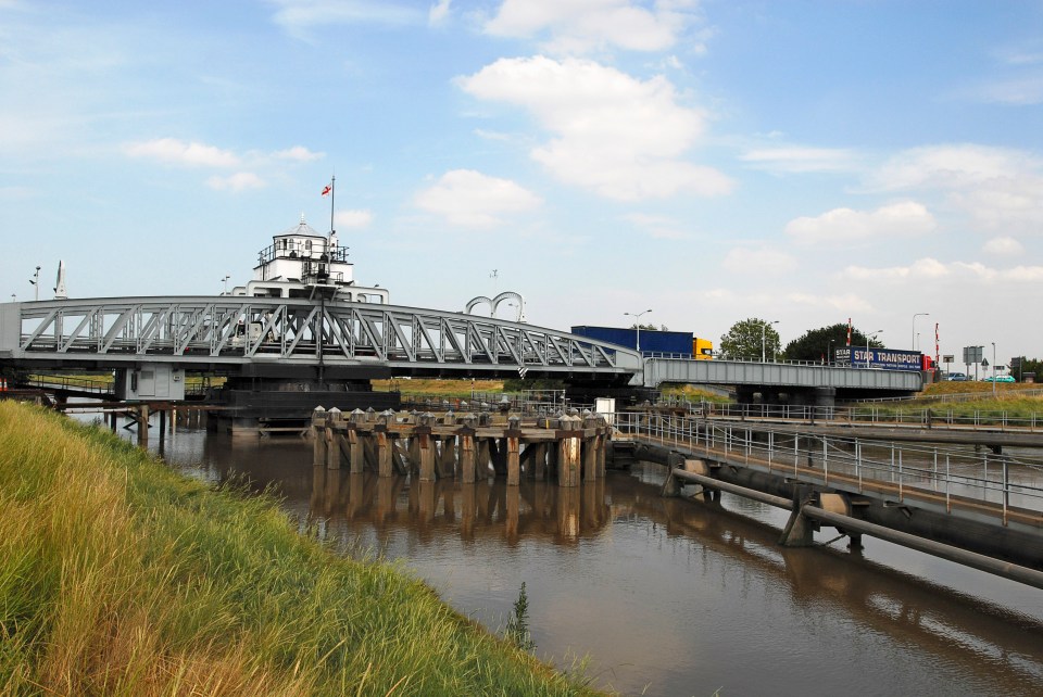 a bridge over a body of water with a truck in the background that says euro transport