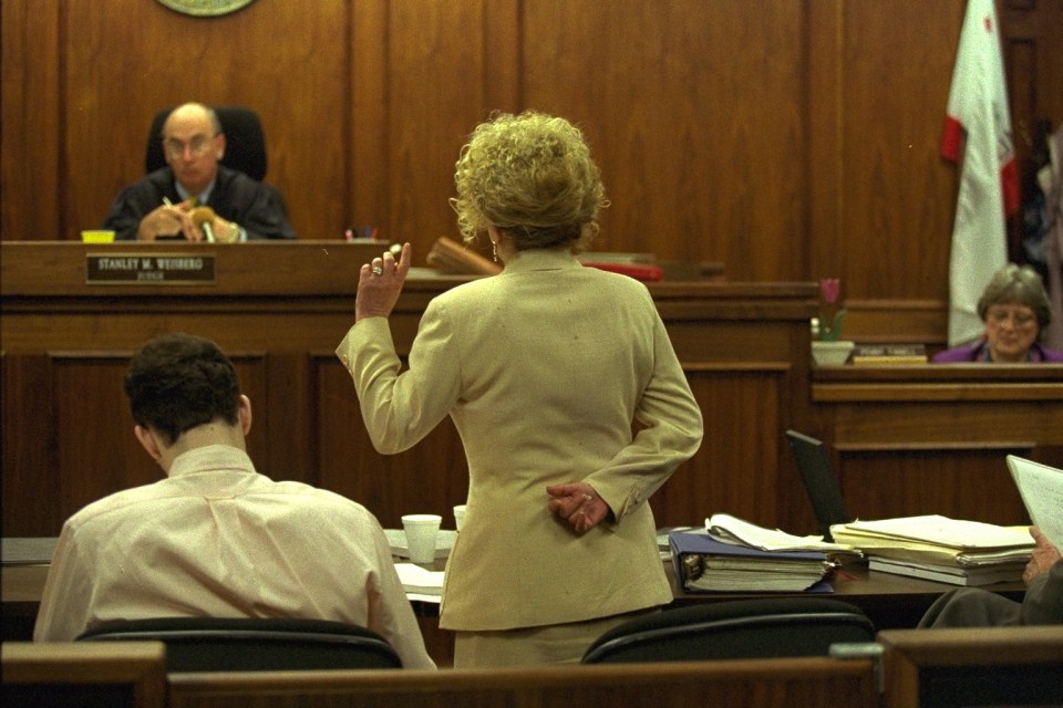 a woman stands in front of a judge named charles