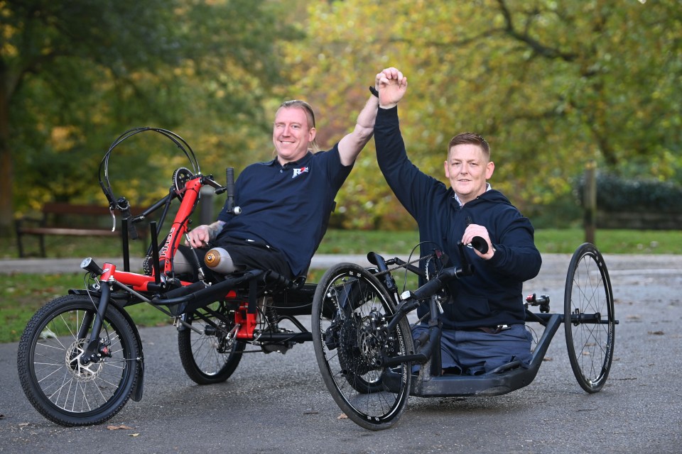 a man with a prosthetic leg sits next to another man on a recumbent bike