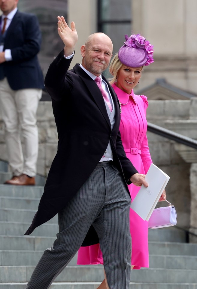 a man in a suit and a woman in a pink dress are waving