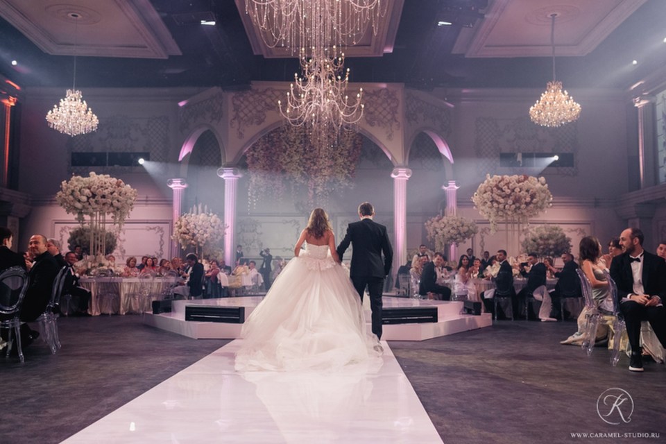 a bride and groom walk down the aisle at their wedding reception