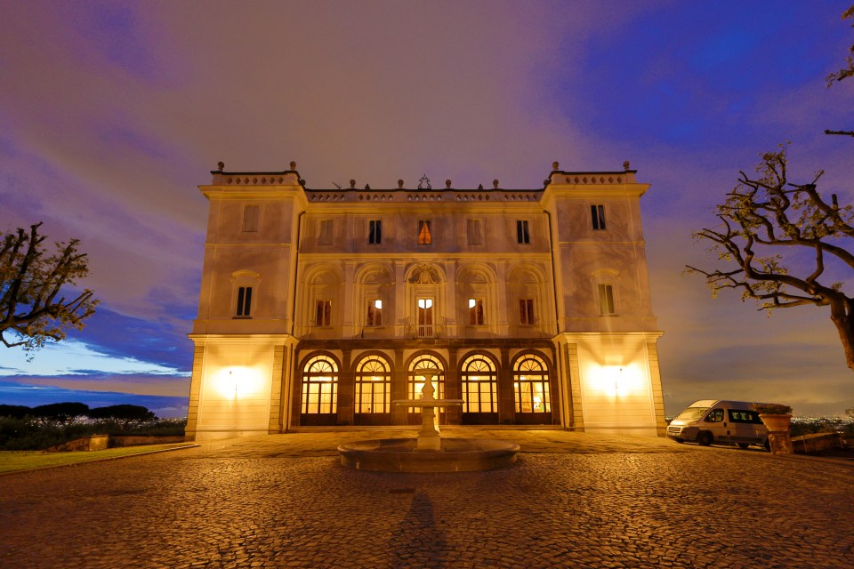 a large building with a fountain in front of it