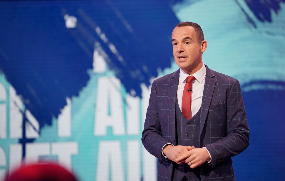 a man in a suit and tie stands in front of a screen that says get all