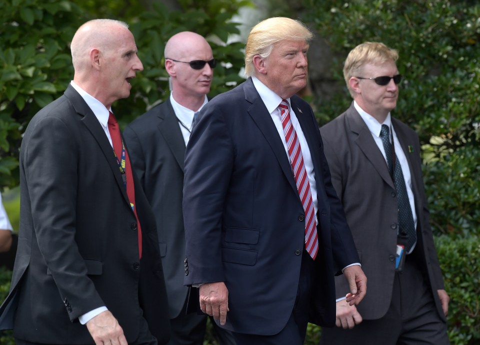 President Donald Trump, his longtime bodyguard Keith Schiller, left, and two Secret Service agents