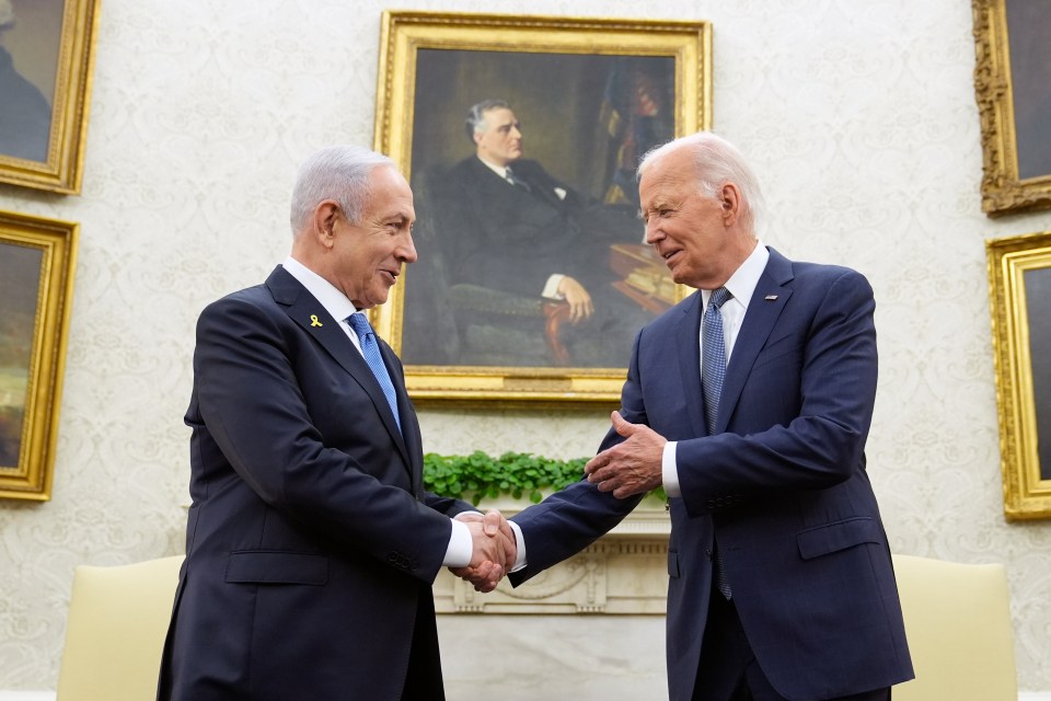 two men shaking hands in front of a painting of a man