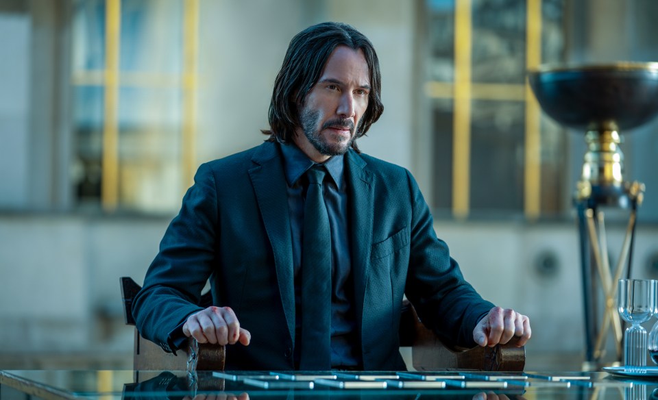 a man in a suit and tie is sitting at a table