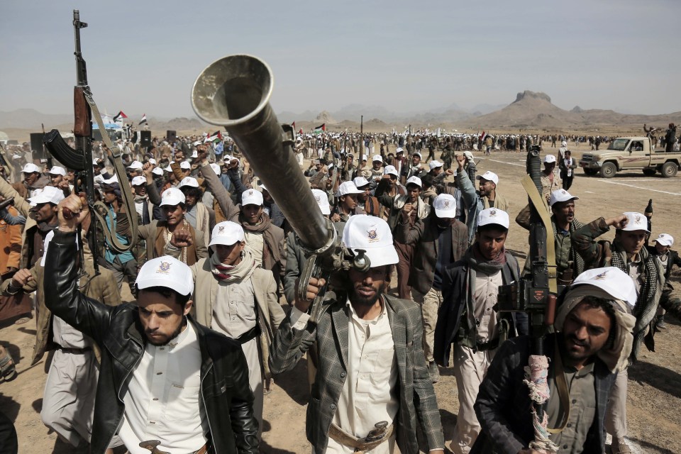 a group of men wearing white hats with arabic writing on them