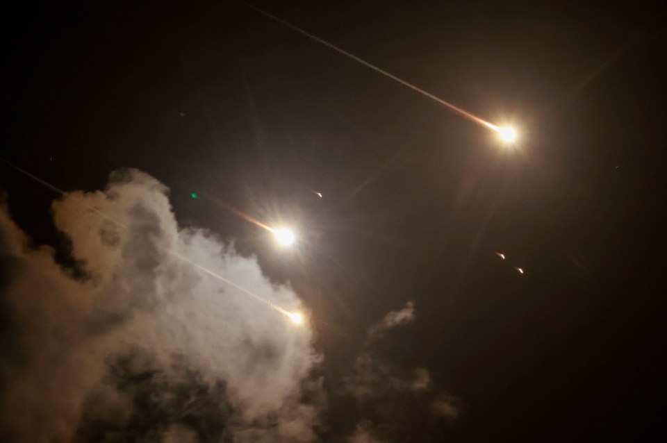 Projectiles are seen in the sky after Iran fired a salvo of ballistic missiles