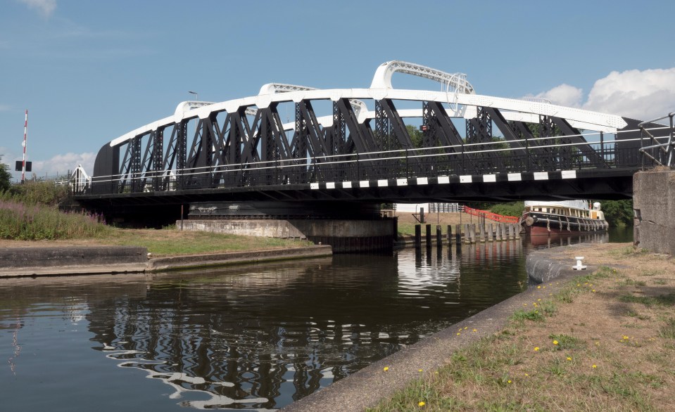 a bridge over a body of water with a reflection of the bridge in the water