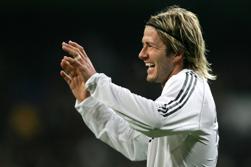 a soccer player wearing a headband is clapping his hands