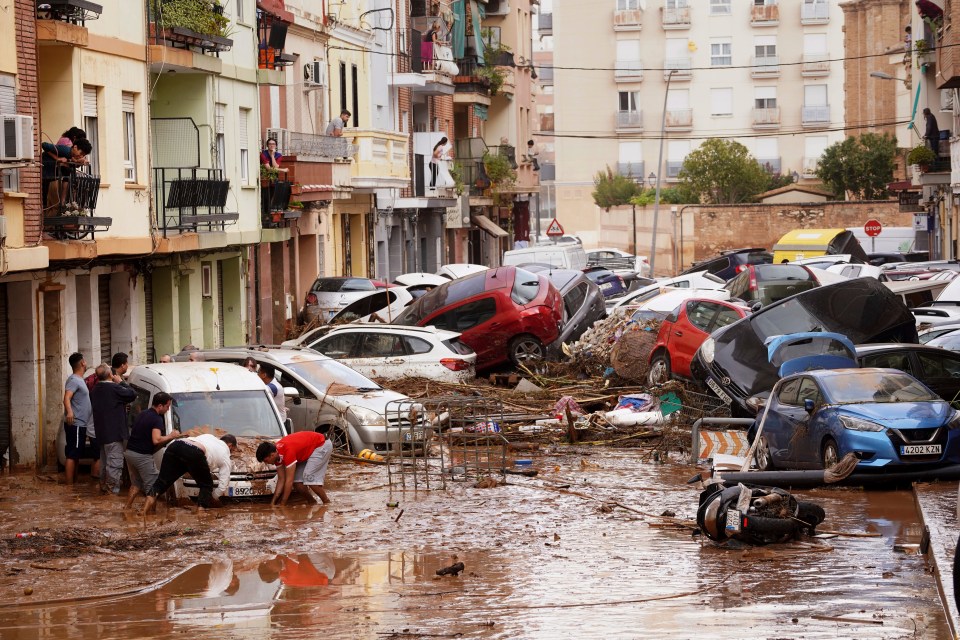 A photograph taken in Valencia on October 30 shows cars piled high after devastating floods