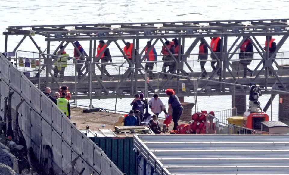 People thought to be migrants depart a Border Force vessel following a small boat incident in the Channel