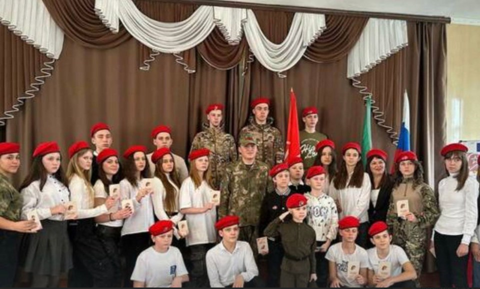 a group of people in military uniforms are posing for a picture .