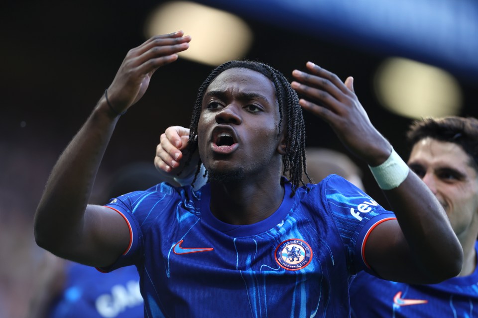 a soccer player wearing a blue shirt that says chelsea on it