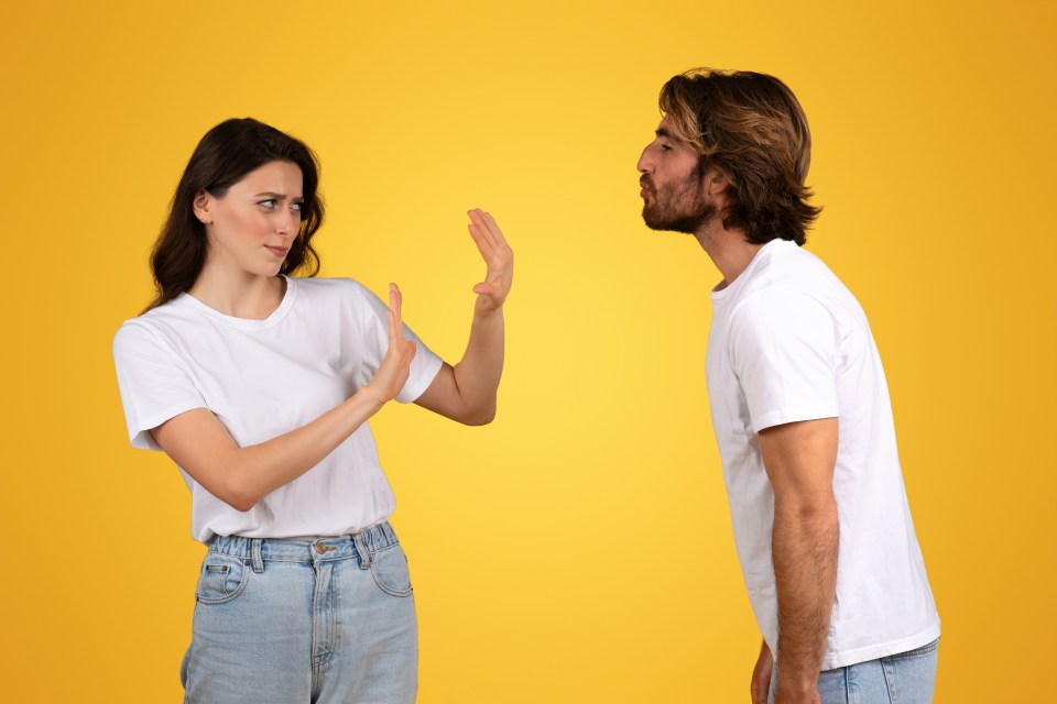 a woman in a white shirt refuses to kiss a man in a white shirt