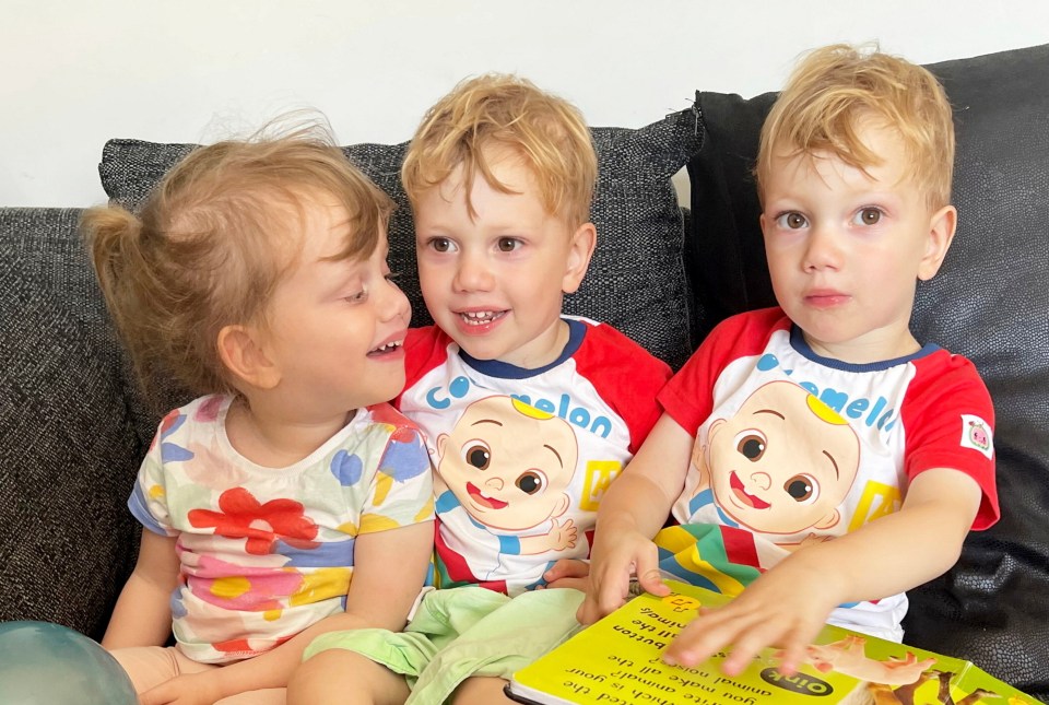 two boys and a girl are sitting on a couch wearing cocomelon shirts