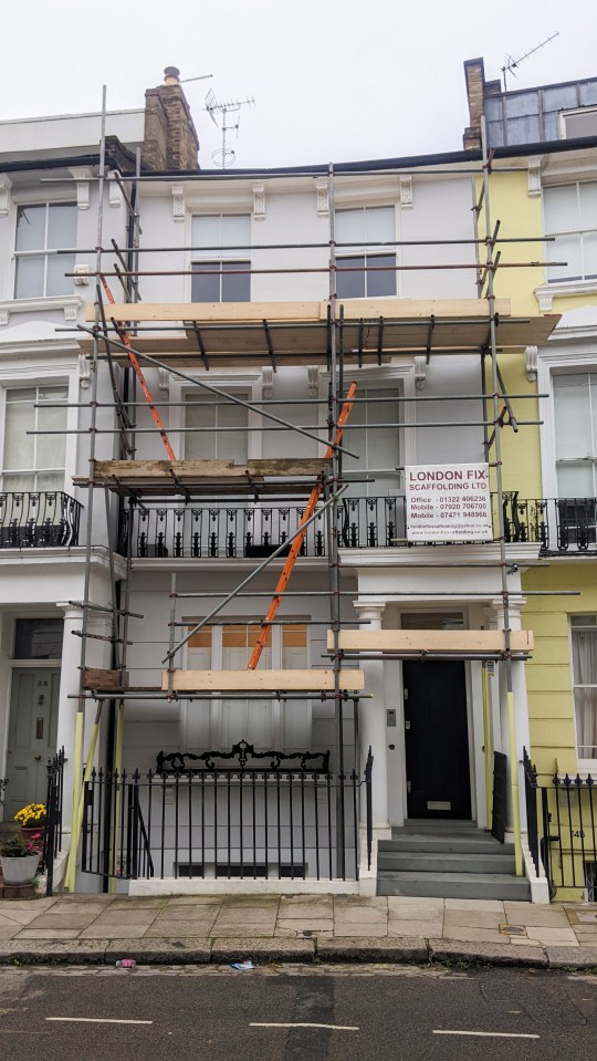 a building with scaffolding and a sign that says london fix