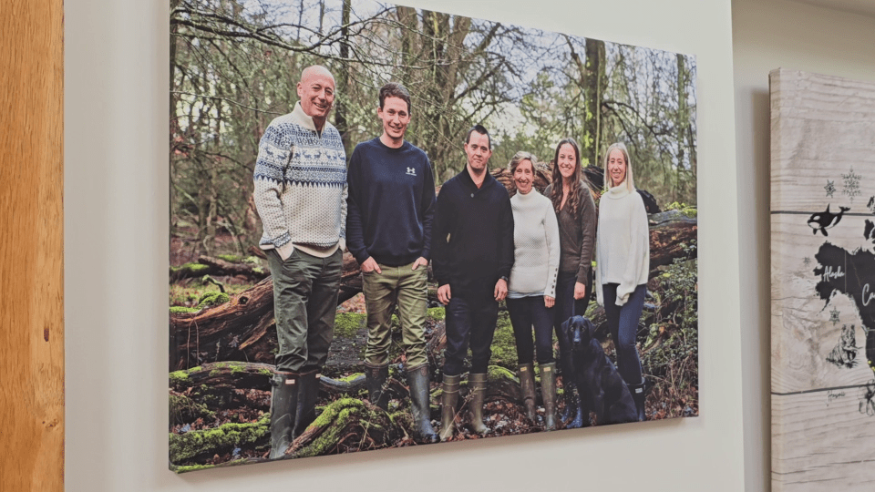 a large canvas of a family standing in the woods