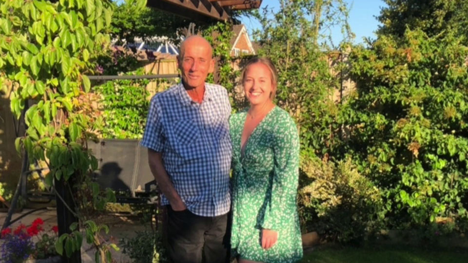 a man and a woman standing next to each other in a garden