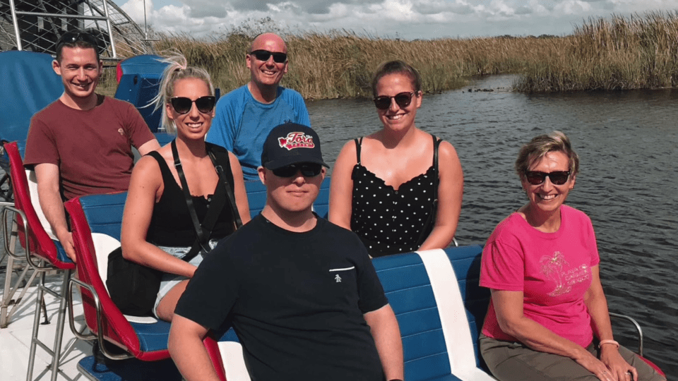 a group of people on a boat with one wearing a hat that says gators