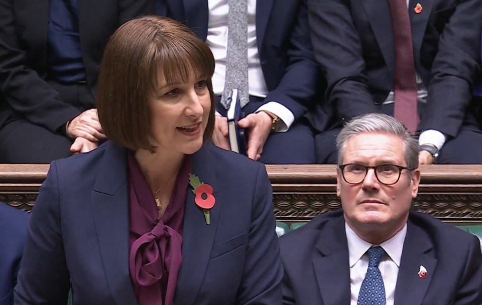 a woman wearing a poppy pin sits next to a man wearing glasses