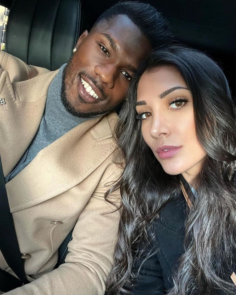 a man and a woman are posing for a picture in a car