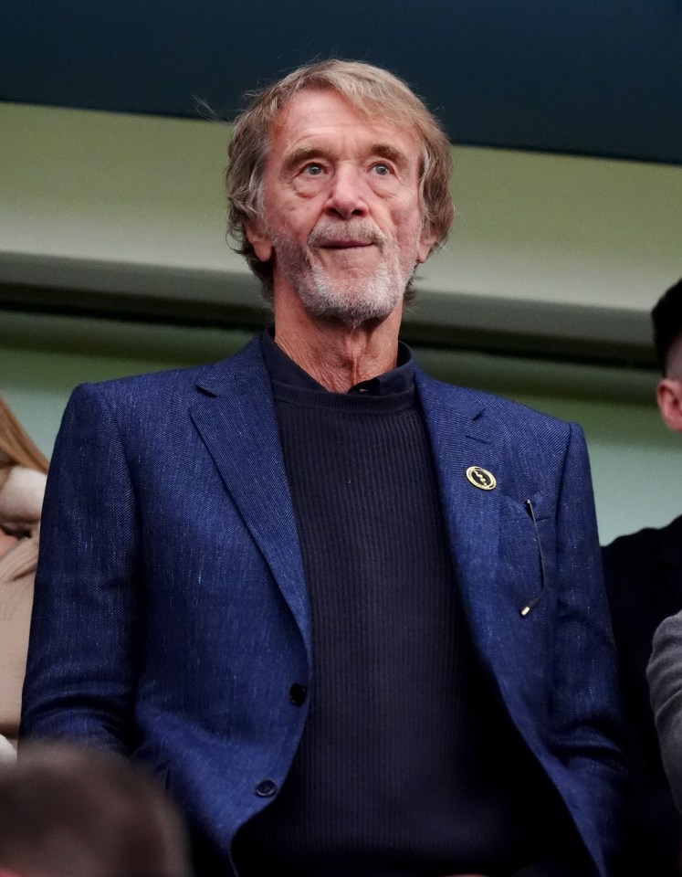 a man wearing a blue jacket and a black sweater has a badge with the letter o on it