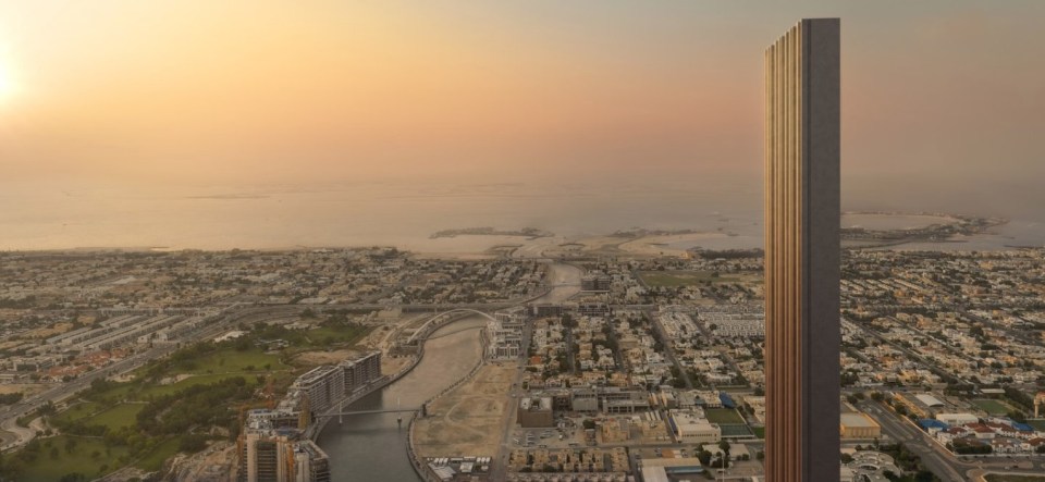 an aerial view of a city with a tall building in the foreground