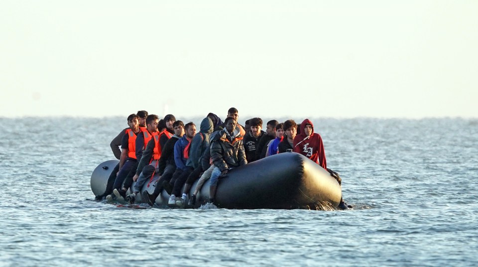 a group of people in a boat with one wearing a hoodie that says ' abercrombie & fitch ' on it