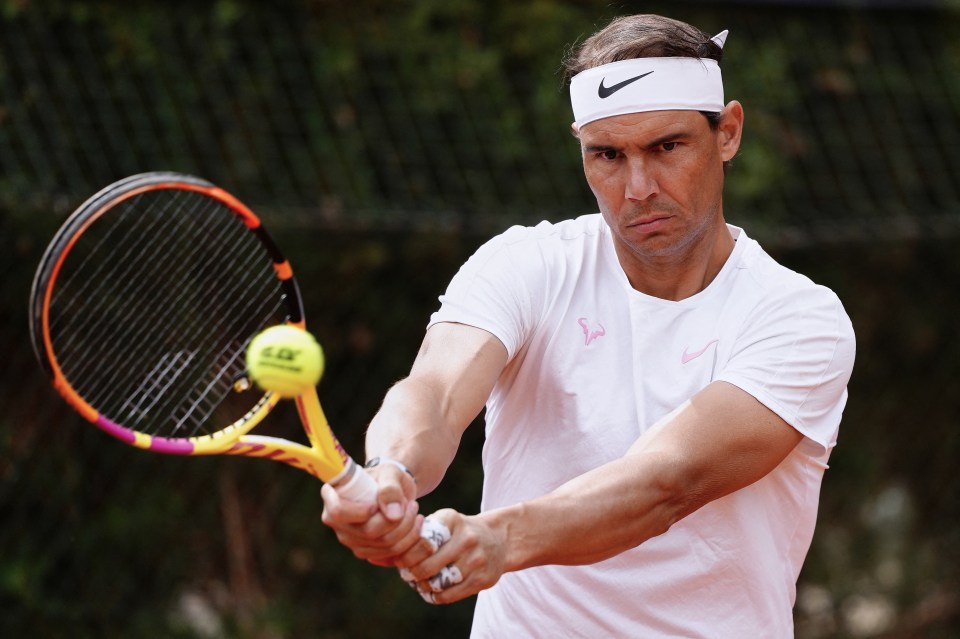 a man wearing a nike headband is playing tennis