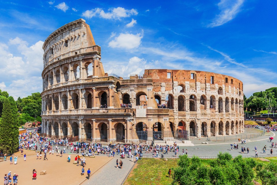 a crowd of people are gathered in front of the colosseum in rome