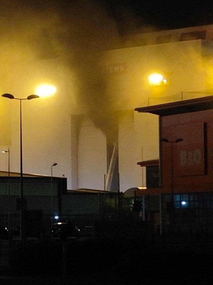 smoke is coming out of a building that says b&q