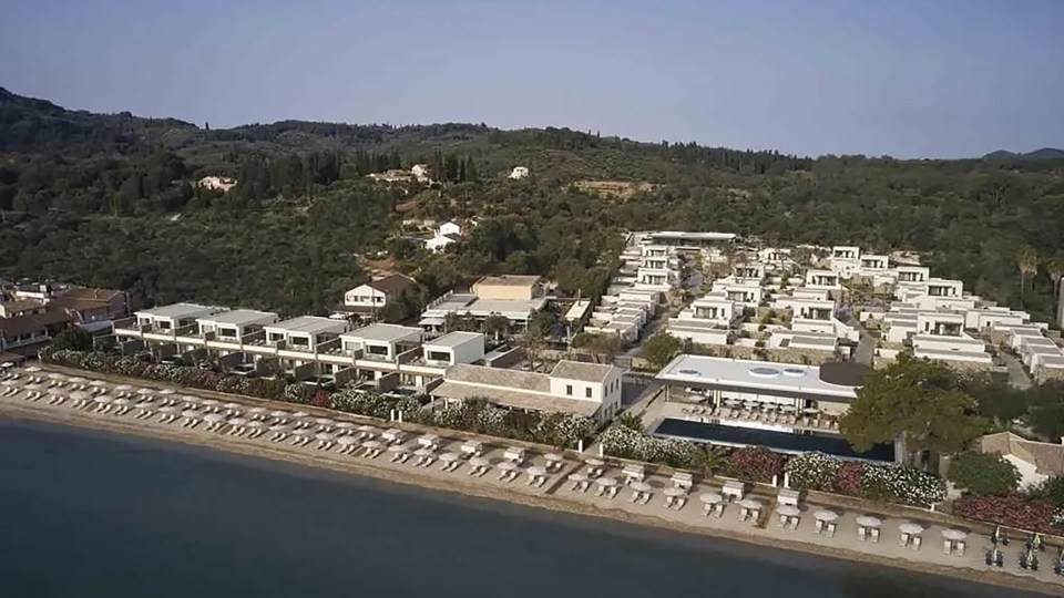 an aerial view of a beach resort with lots of umbrellas