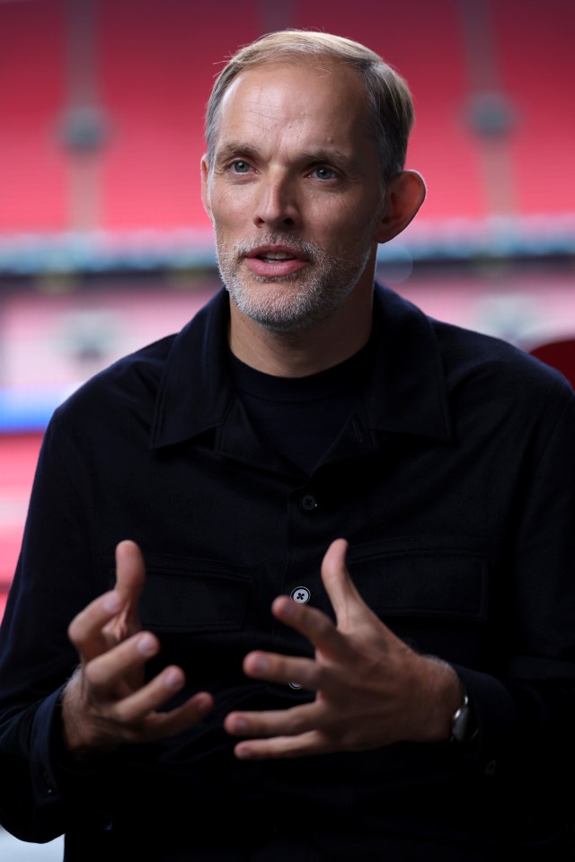 a man with a beard wearing a black shirt has his hands outstretched