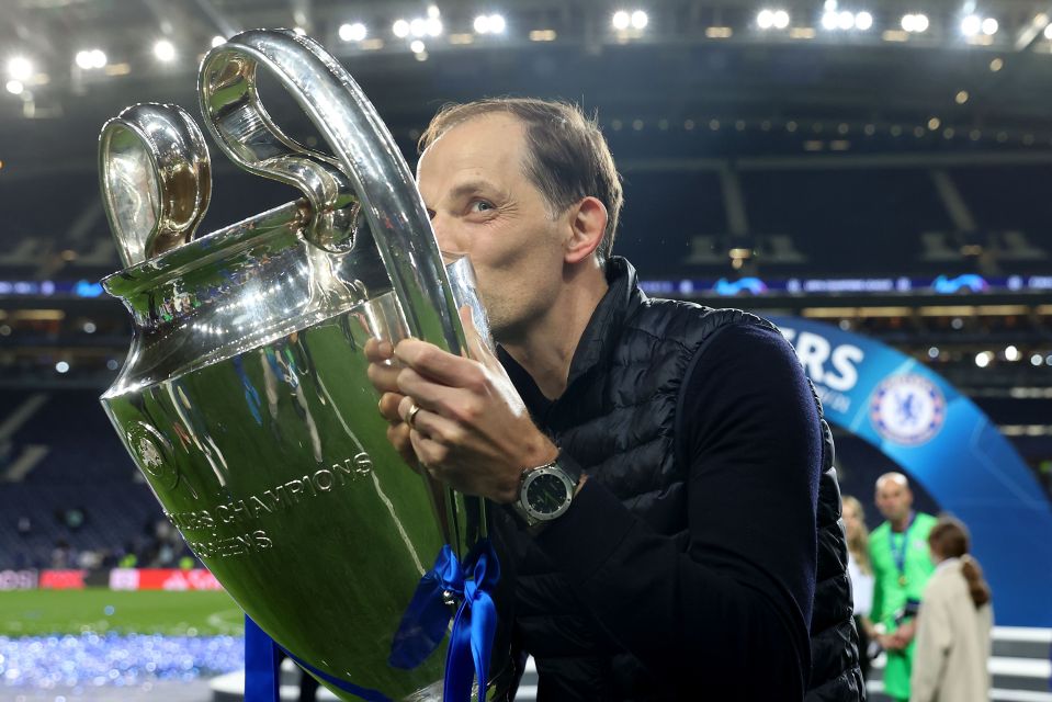 a man kisses a trophy that says champions league on it