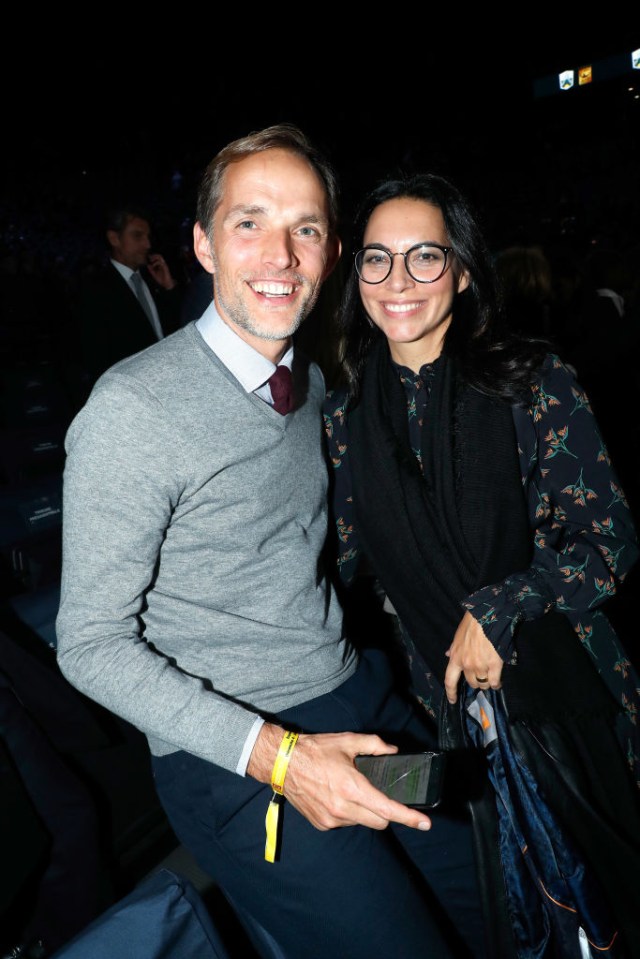 a man and woman pose for a picture in a dark room